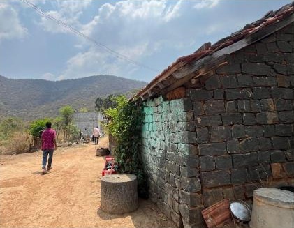 Stone building, earthen path and surrounding hills shown in the Anotherway presentation